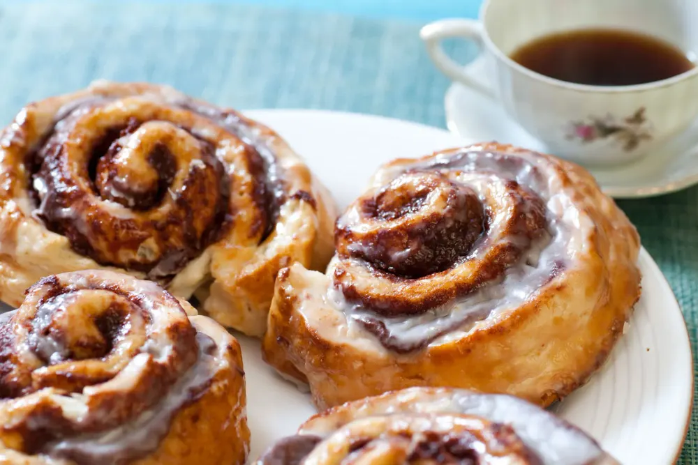 Glazed cinnamon rolls with a cup of coffee